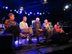 a row of people sitting on a stage